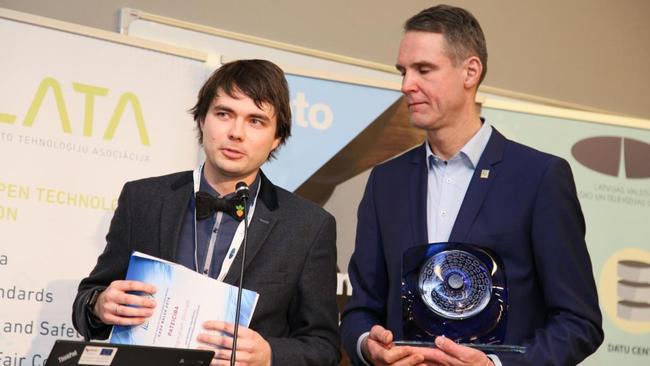 Two men standing with awards in the LATA conference