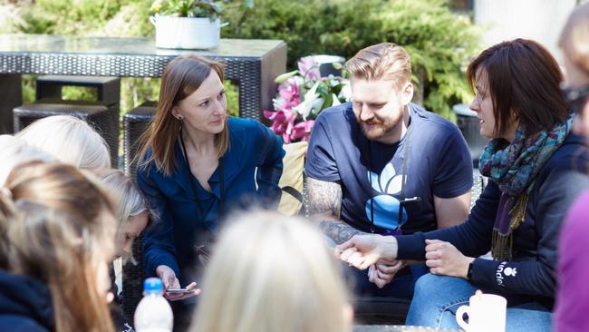 People sitting together outside talking