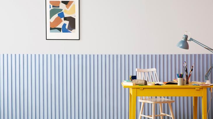 Blue painted kids room with a desk