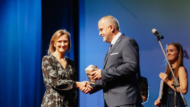 Ilze receiving an award from mayor of Valmiera
