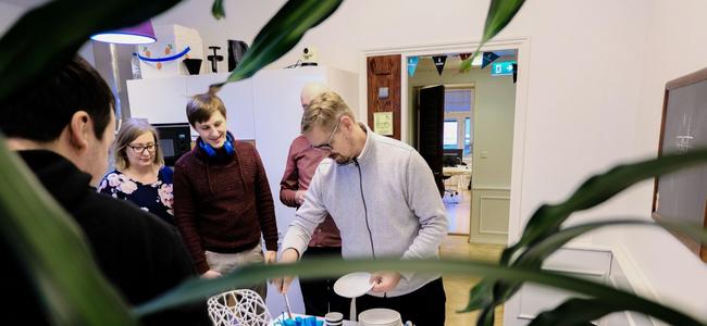 Huijareita Drupal-aiheisen kakun ympärillä Wunder Helsingin toimiston keittiössä.
