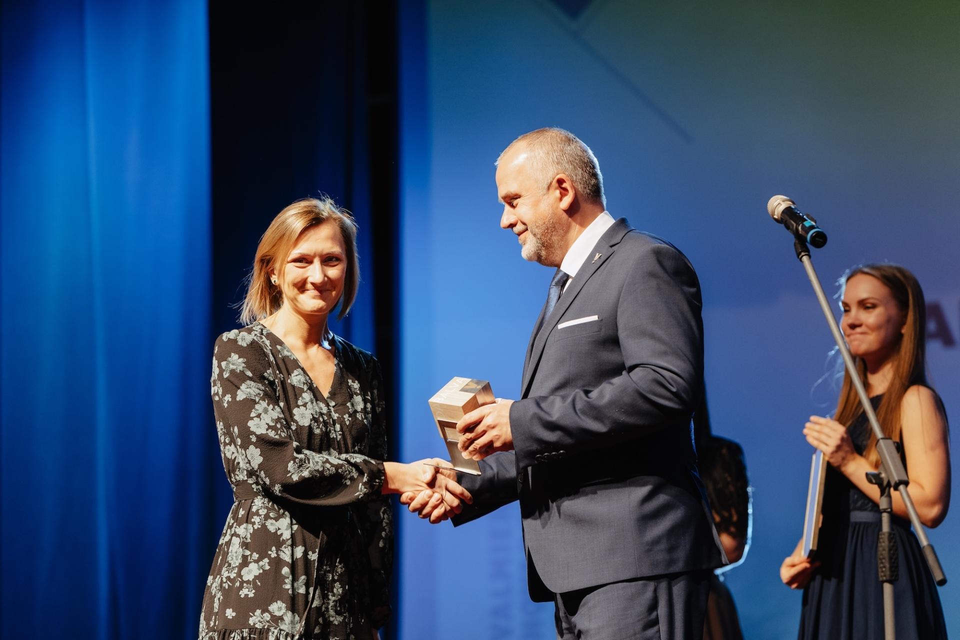 Ilze receiving an award from mayor of Valmiera