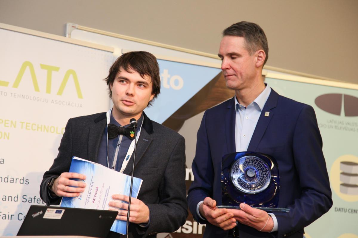 Two men standing with awards in the LATA conference